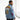 Three-quarter view of Omega Denim Jacket emphasizing vibrant patches and embroidery with soft studio lighting.
