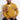 Close-up of Omega Varsity Cardigan's chenille embroidery, textured acrylic fabric, and 7-button closure on a seated model.